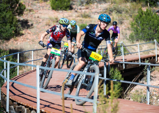 Mountain bikers racing on a bridge